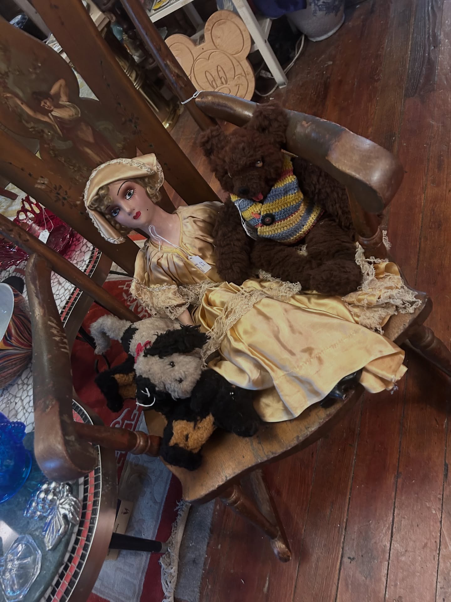 Antique boudoir doll on wooden chair