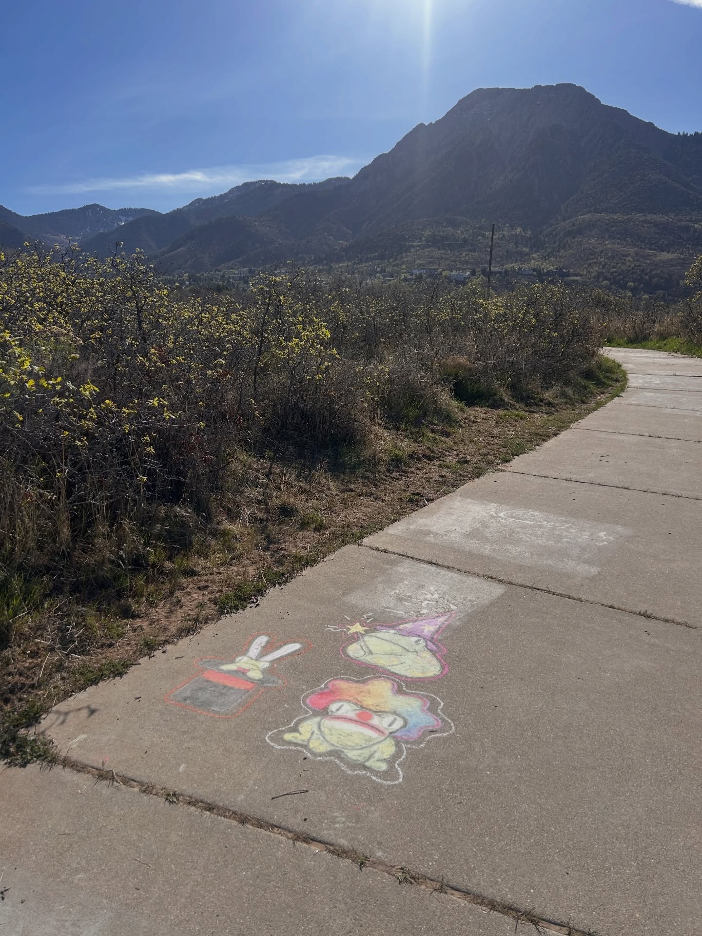 Sidewalk chalk art with mountain backdrop
