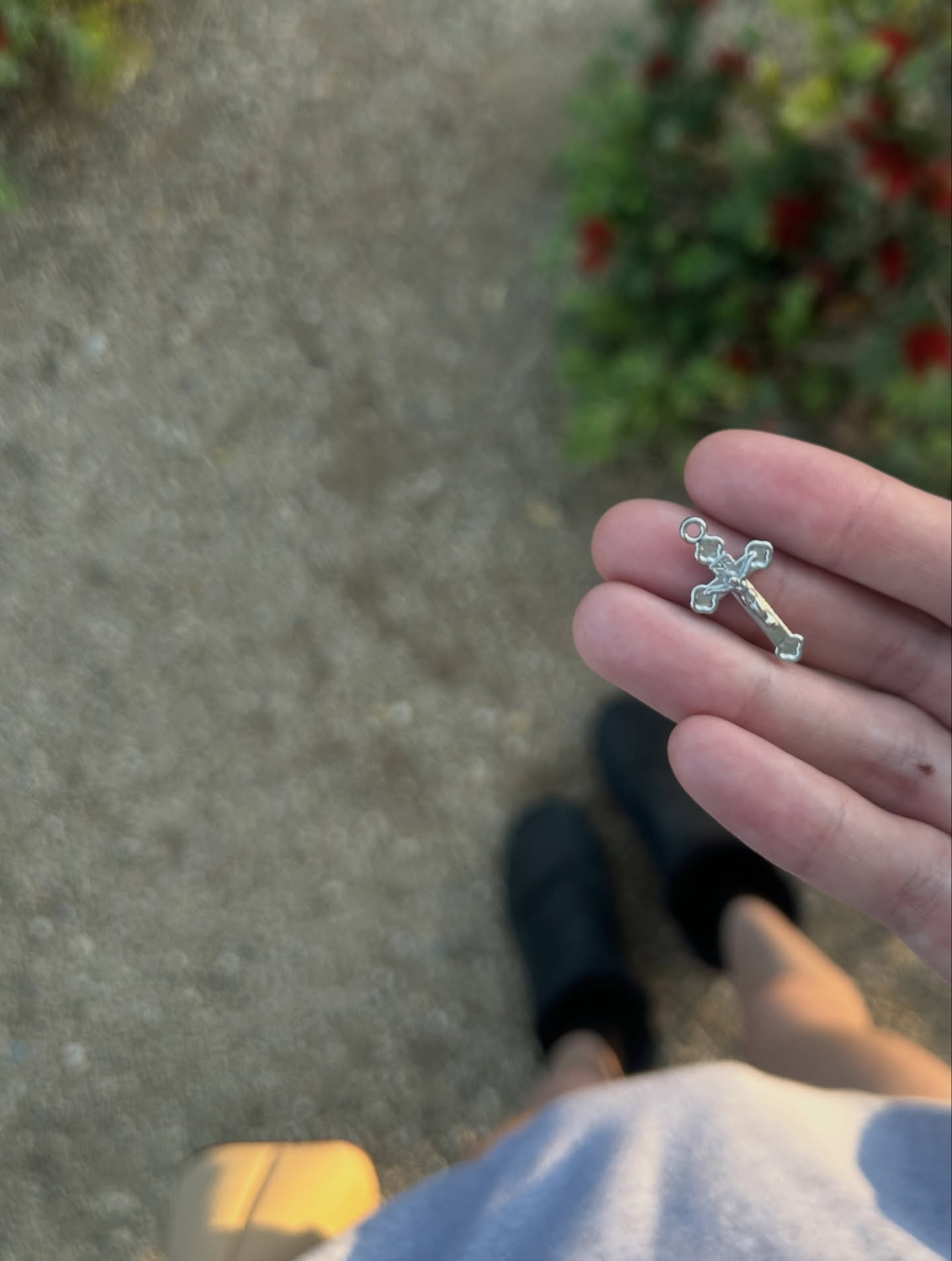Silver crucifix pendant found outdoors